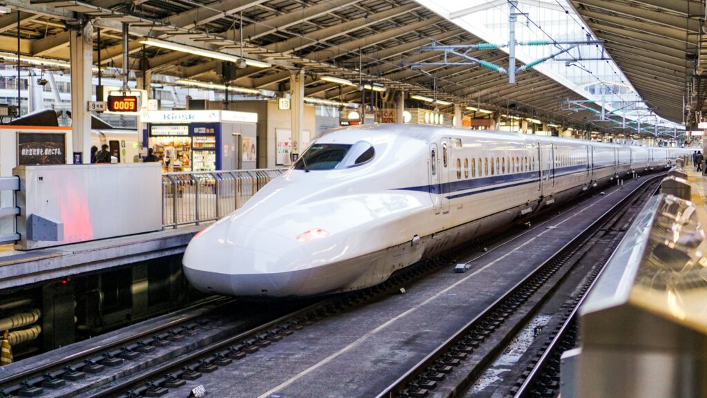 A Japanese bullet train (shinkansen) arriving at a station.